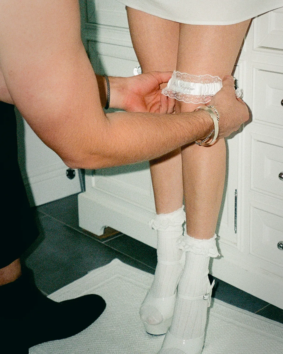 Grainy Kodak Portra film scan showing warm skin tones at a wedding